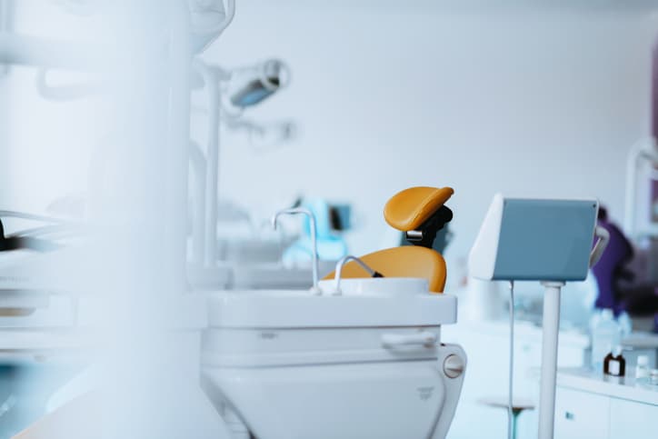 Modern dental treatment room with dental chair and equipment